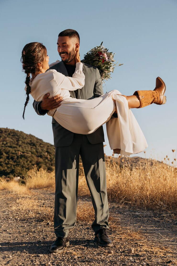 smiley groom holding bride